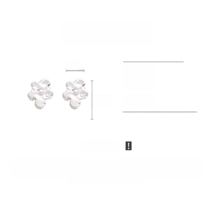 Macro shot of matte silver flower earrings with white beads and 3.5cm size details
