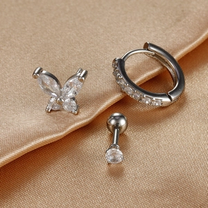 Three-piece silver earring set with butterfly stud and zircon hoops on champagne silk