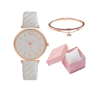 Close-up of rose gold watch and star pendant bracelet in a pink gift box set