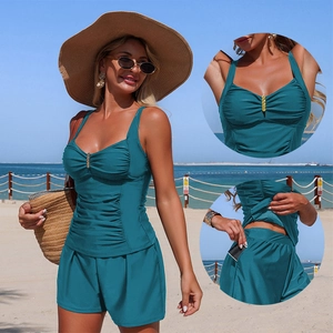 Teal two-piece tankini set with ruched camisole top and wide-leg shorts featuring pockets