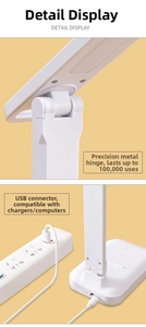 Detail of adjustable metal hinge and USB power connection on a white LED desk lamp