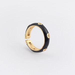 Detail of adjustable gold ring with black enamel inlay and sparkling zircon stones