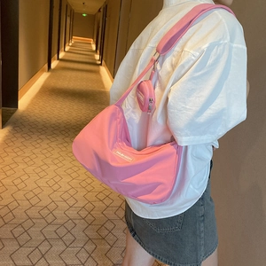 Pink nylon crescent shoulder bag with round coin purse and fashion tag, casual style