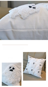Detail of tufted ghost embroidery on a white canvas Halloween pillowcase for home decor