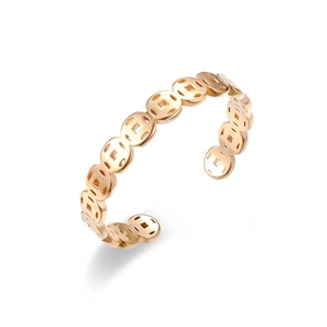 Close-up detail of a rose gold open ring featuring Chinese copper coin motifs and textures