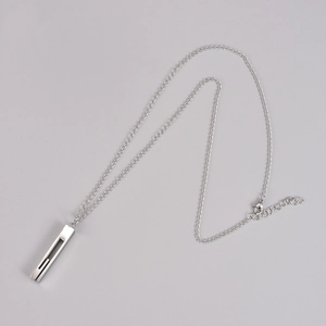 Flat lay of minimalist silver stainless steel necklace with hollow rectangular pendant