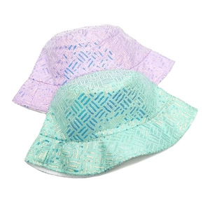 Detail of sequin grid patterns on purple and green reflective bucket hats for outdoor wear