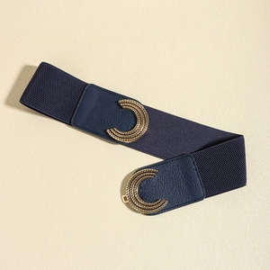 Detail of navy blue elastic wide belt with golden textured C-shape interlocking buckle
