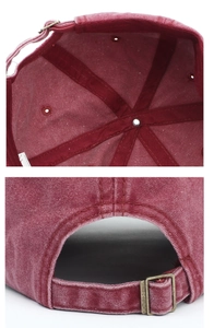 Macro detail of washed burgundy baseball cap showing inner cotton lining and metal buckle