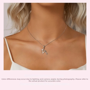 Close-up of s925 silver Tree of Life pendant with gold plating and white zircon on neck