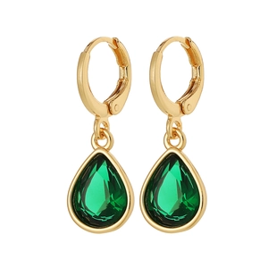 Detailed macro of gold drop earrings featuring pear-shaped green faceted gemstones