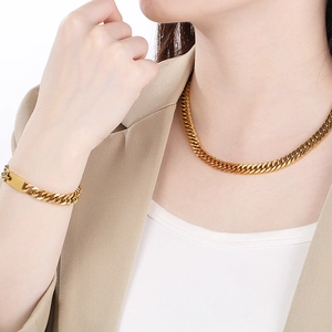 Golden titanium steel Cuban chain necklace and bracelet set featuring a polished finish