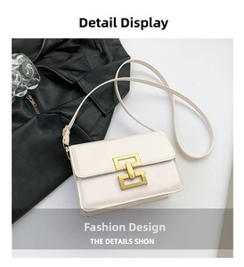 Detail shot of the vintage white crossbody bag with a golden square interlocking buckle