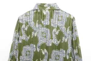 Detail of green paisley print shirt featuring vertical stripe textured fabric