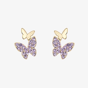 Detailed close-up of golden butterfly earrings with purple crystals and polished finish