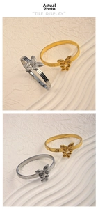 Detail of 18K gold and silver layered butterfly bracelets with fine wing texture