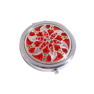 Vintage bronze round makeup mirror with red and green rhinestones and silver leaf design