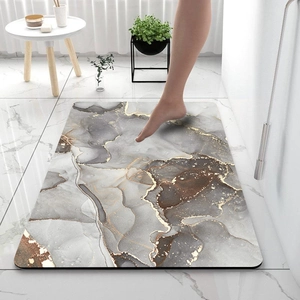 Close-up of marble texture diatom mud bath mat with gold veins and non-slip surface