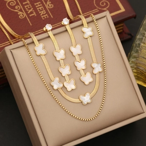 Elegant gold butterfly jewelry set including double necklace, bracelet, and stud earrings