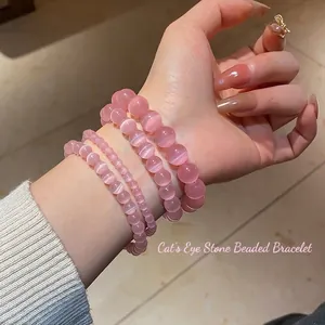 Elegant four-piece set of pink cat eye stone beaded bracelets worn by a female model