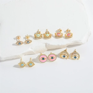 Macro detail of French vintage Evil Eye stud earring set with colorful enamel on white stone