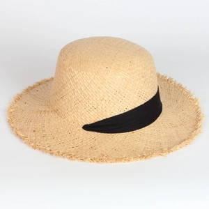 Detail view of woven raffia sun hat with black ribbon trim and frayed edge brim