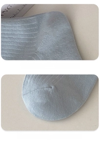 Detailed view of reinforced toe and 3D heel on light blue ribbed cotton socks