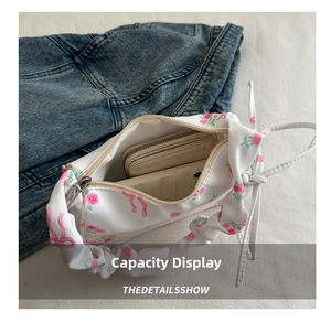 Top view of white canvas shoulder bag showing internal capacity for wallet and phone