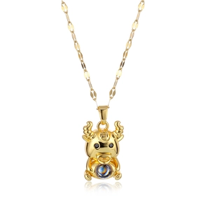 Gold zodiac ox pendant necklace with a projection stone on a clean white background