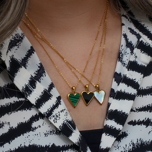 Three-layer gold necklace with green malachite, black onyx and white shell heart pendants