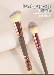 Close-up of dual-ended makeup brush with rose gold ferrule and angled soft bristles
