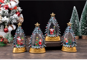 Set of four light-up Christmas tree snow globes with gold bases and holiday scenes