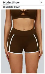 Close-up of chocolate brown yoga shorts with white contrast binding and elastic fabric