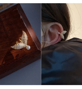Detailed close-up and model shot of a gold fishtail ear cuff with pearls and zircons