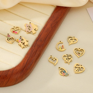 Golden heart pendants with colorful enamel and diamonds on beige velvet jewelry tray