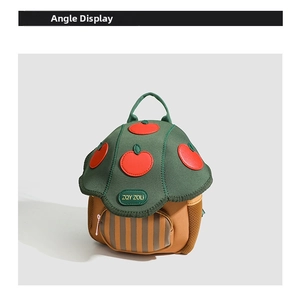 Detail view of cartoon mushroom toddler backpack with red apple patches and mesh pocket