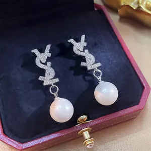 Elegant silver pearl drop earrings featuring a crystal-encrusted VSL logo in a gift box