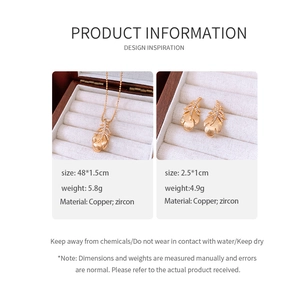 Detail of 18k gold plated feather necklace and earrings set with sparkling zircon stones