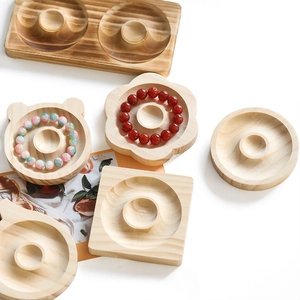 Detailed view of assorted natural wood jewelry trays with round grooves and wood grain
