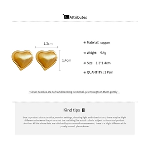 Detail view of heart-shaped copper stud earrings with size and material specifications