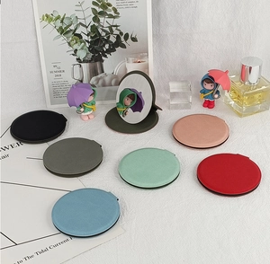 Flat lay of colorful PU leather folding mirrors in multiple colors on a stylish background