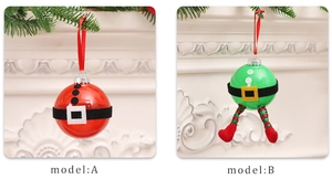 Detail of red and green decorative Christmas ornaments with plush belts on a white mantel