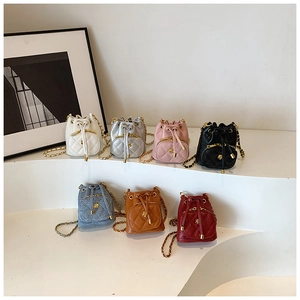Detail showing seven colors of camellia quilted mini bucket bags with gold chain straps