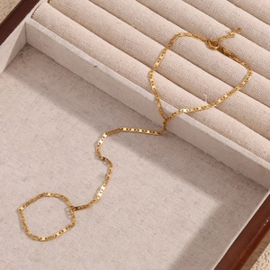 Detail of 18K gold-plated stainless steel slave bracelet with geometric ring link