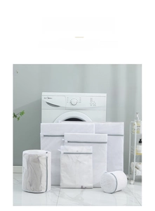 Set of durable milky white mesh laundry bags with grey zippers in a modern laundry room