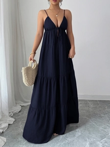 Macro view of dark blue V-neck tiered maxi dress featuring delicate strap details