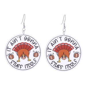 Detail of round acrylic earrings featuring cartoon turkey, pumpkin and funny holiday quote
