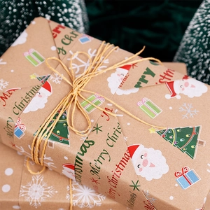 Double-sided kraft Christmas wrapping paper roll with Santa motifs and jute twine