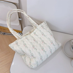 Détail du sac cabas matelassé avec motifs floraux roses et texture en coton doux naturel