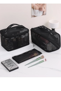 Three-piece black mesh makeup bag set including brushes holder on marble surface